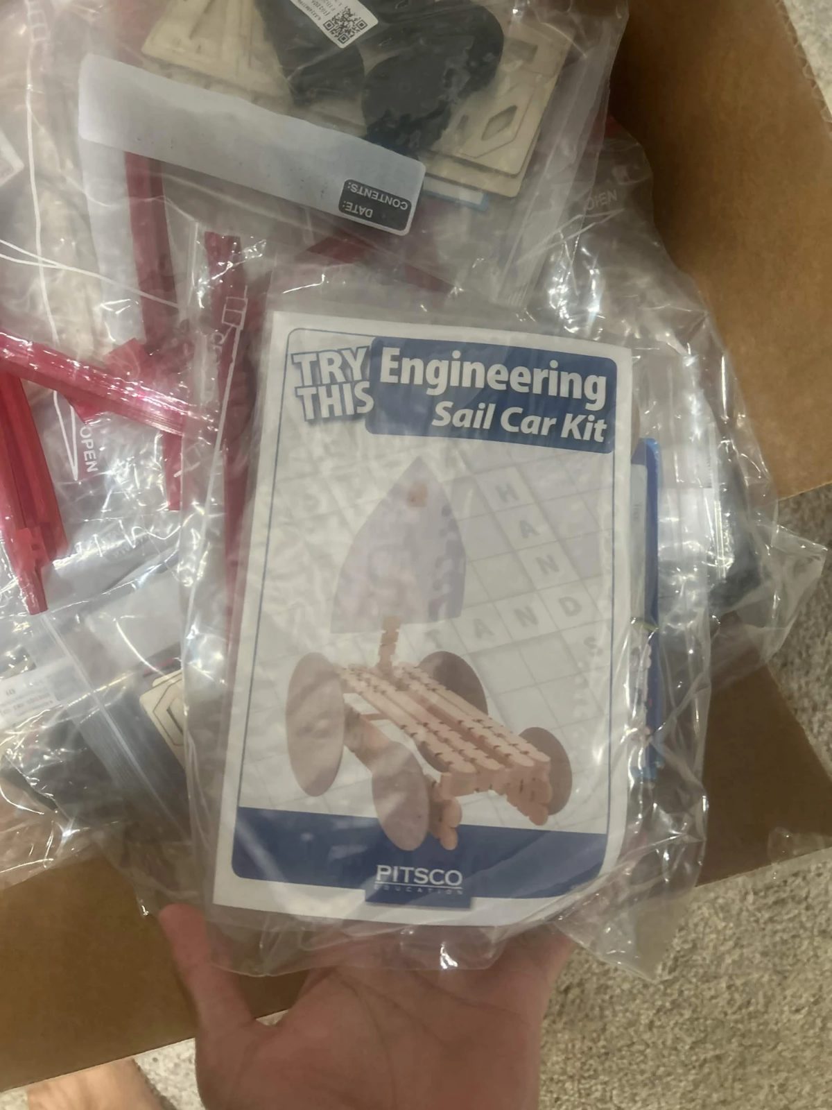 A sealed kit with a sail car instruction card